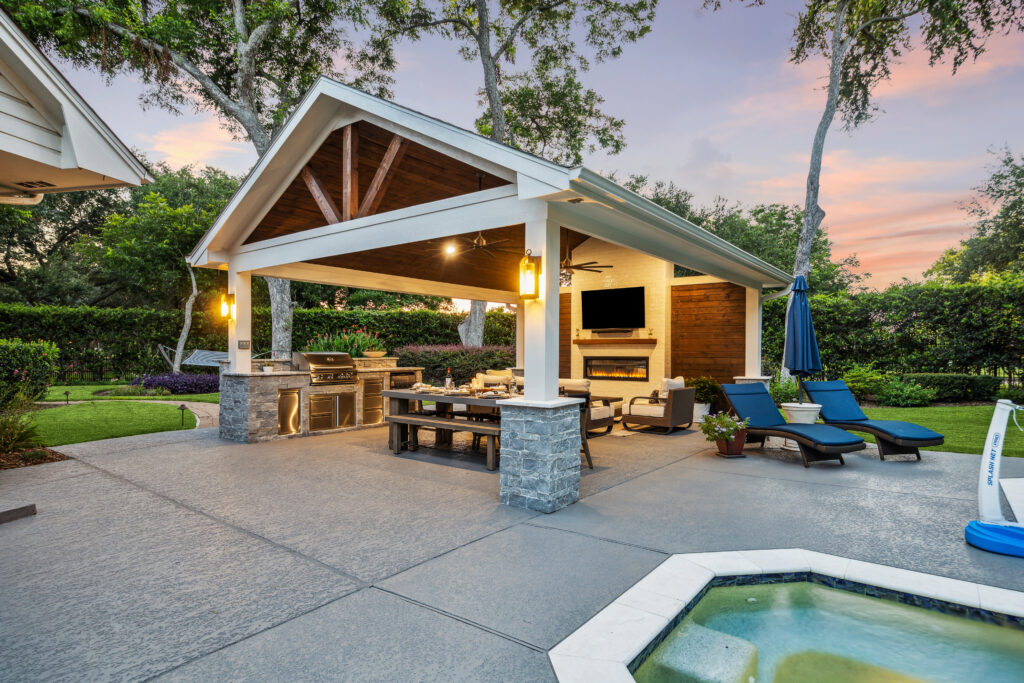 Freestanding patio cover/pool house with a view of the rest of the back yard. 