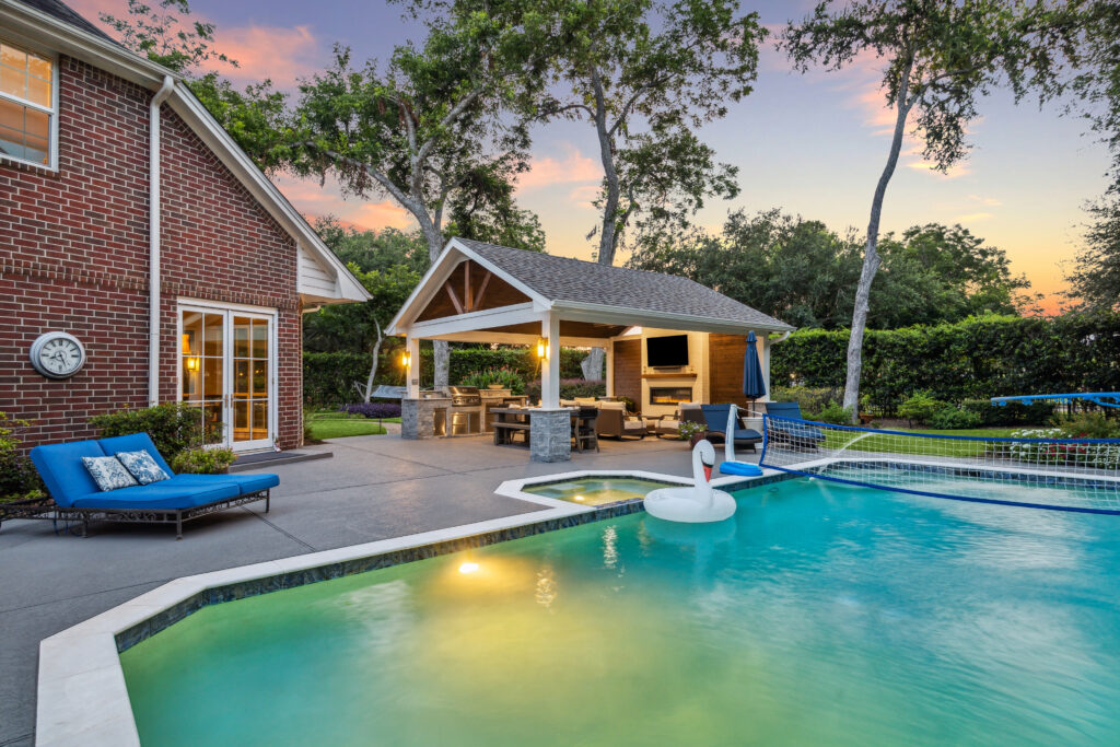 A freestanding patio cover with the pool in the foreground. 